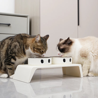 Elevated Kritter Krush pet feeder with stainless steel bowls on a wooden stand for comfortable feeding.